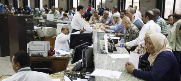 People buy Suez Canal investment certificates at a bank in Cairo